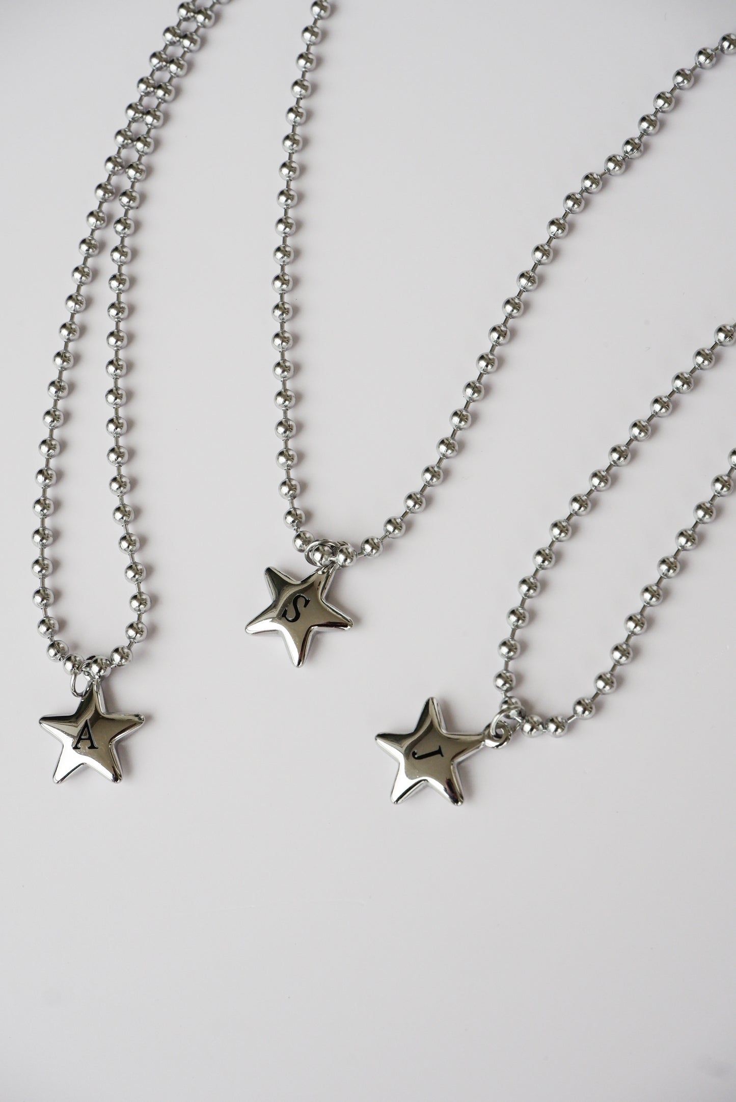 star initial necklace on a stainless steel ball chain