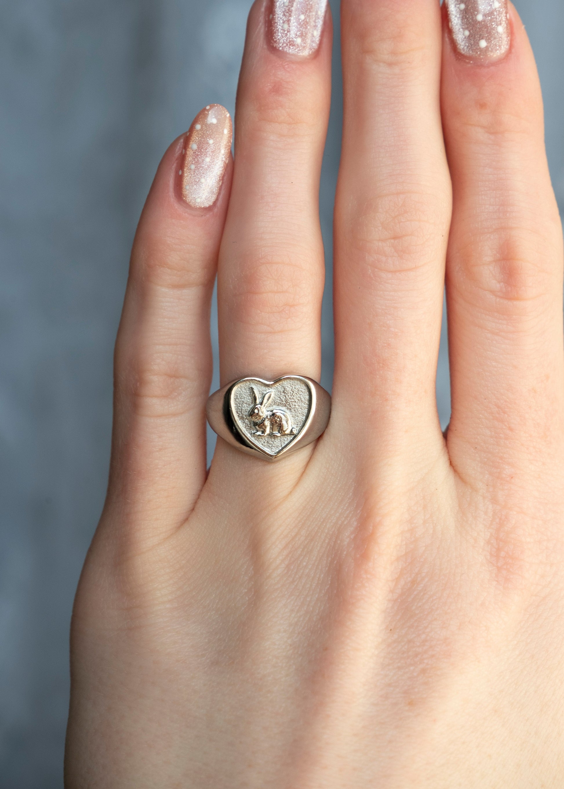 heart shaped ring with a bunny inside