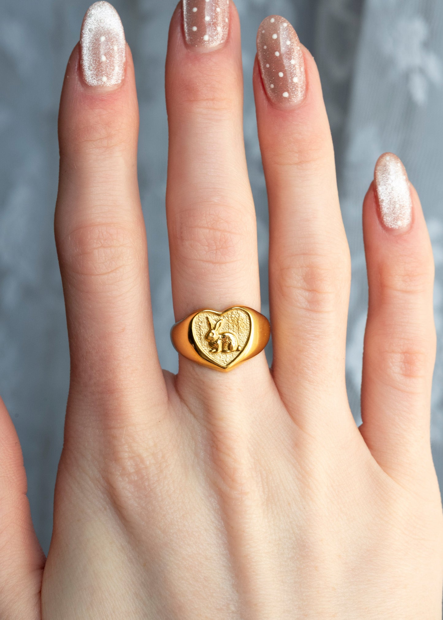 heart shaped ring with a bunny inside