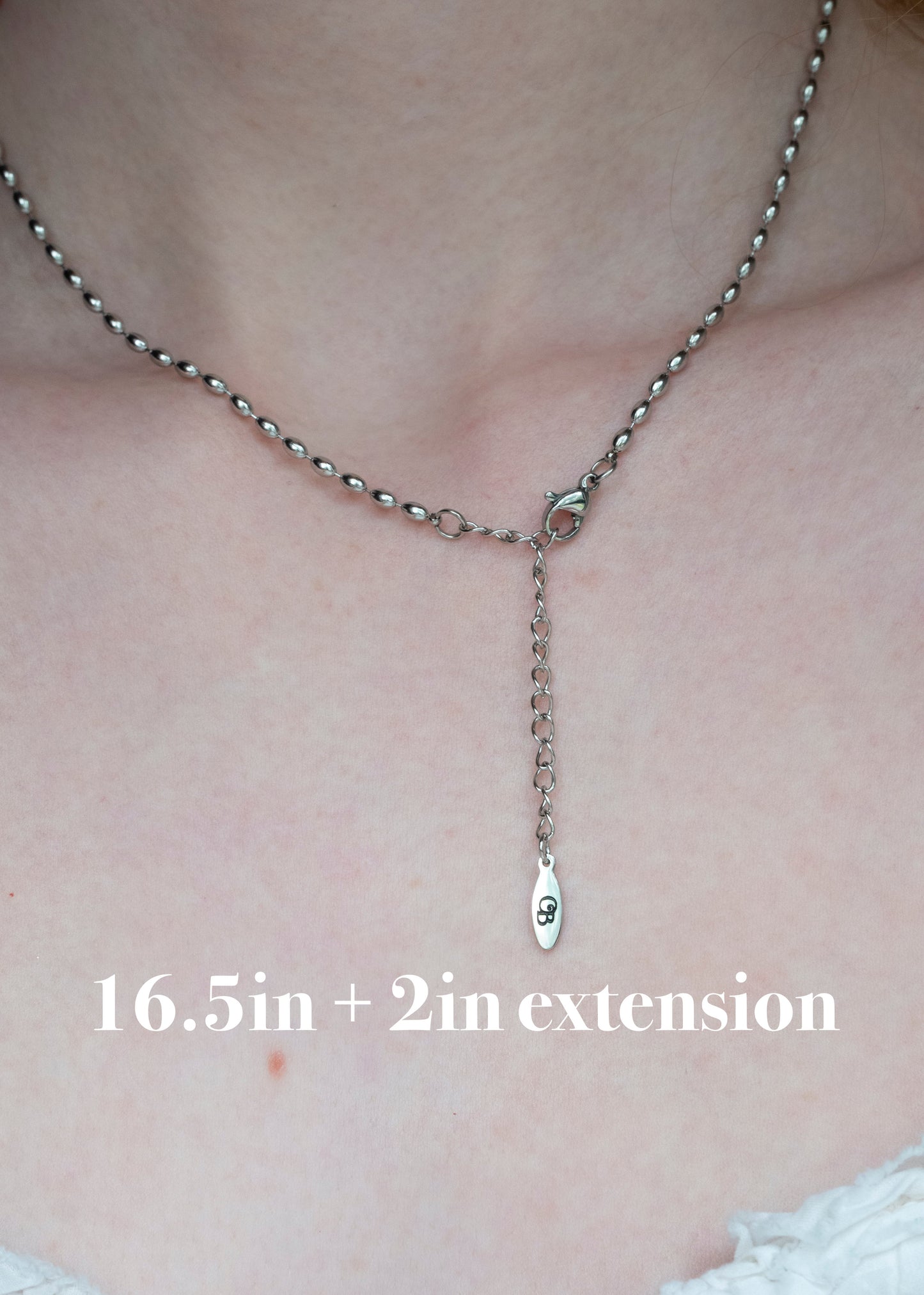 Necklace with clasp on a person's neck, showing extension length.