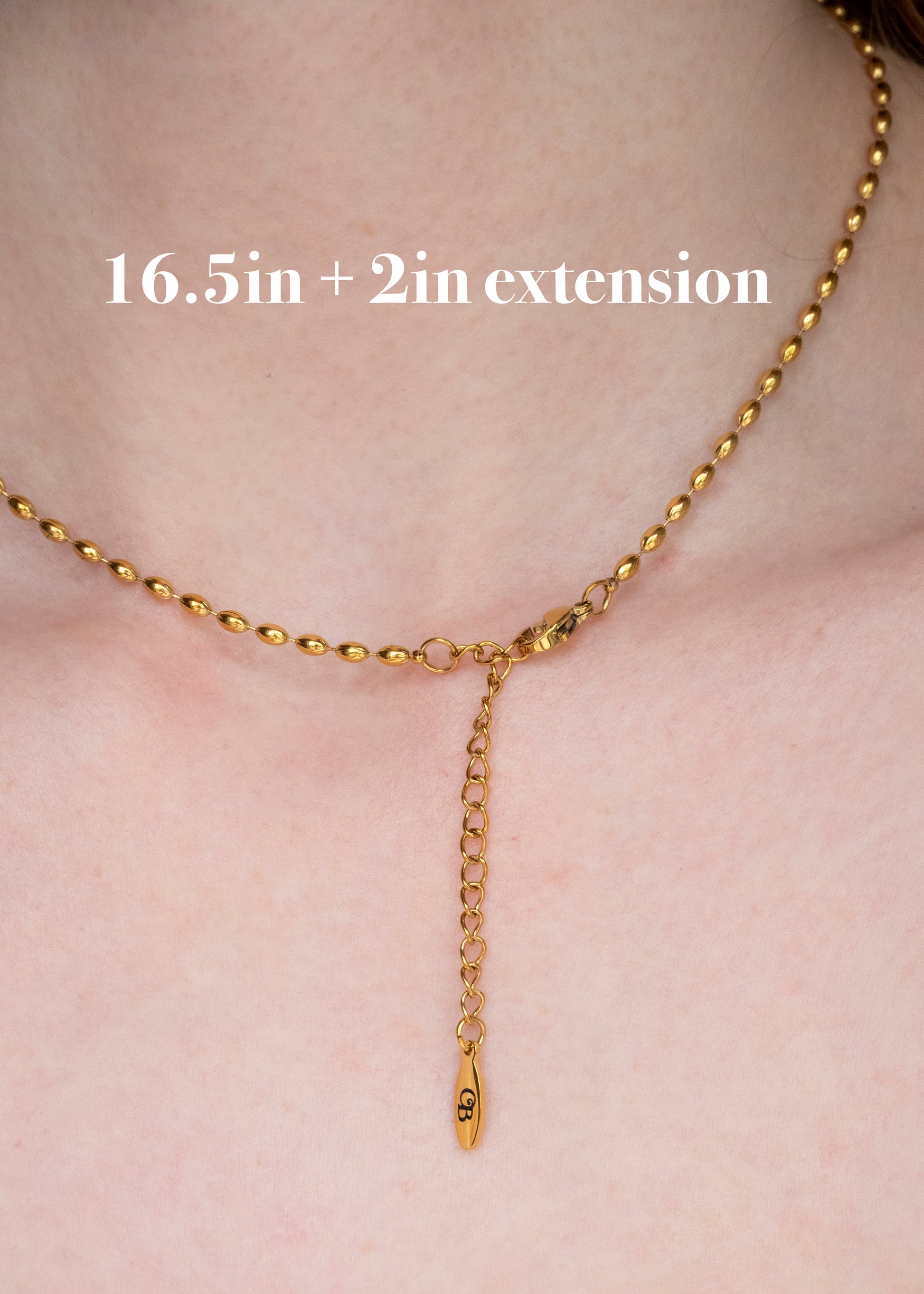 Gold necklace with extension on a person's neck, labeled '16.5in + 2in extension'.